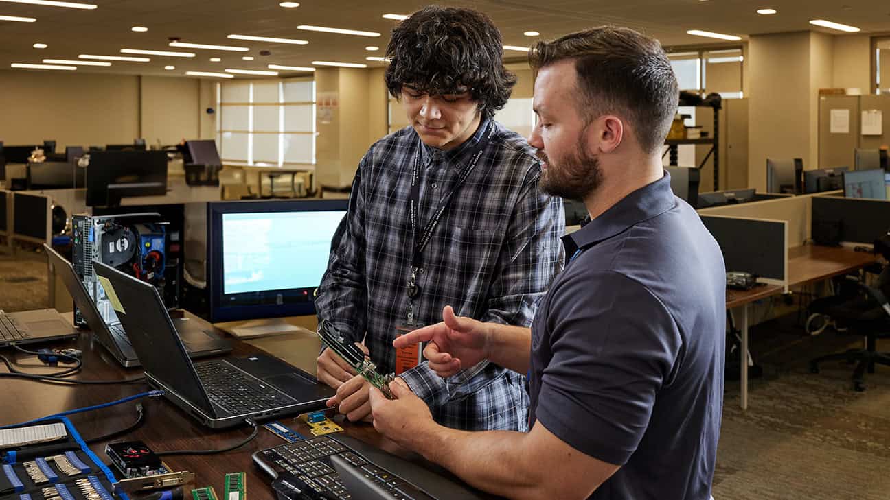 Youth rebuilding a computer in a classroom